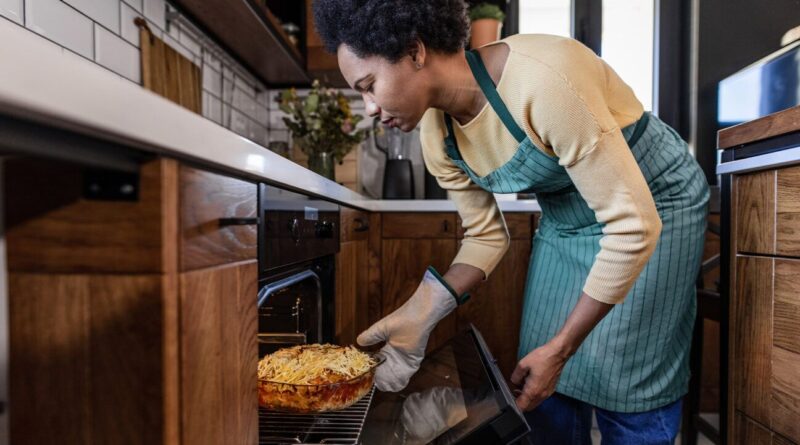 The lady cooks mac and cheese.