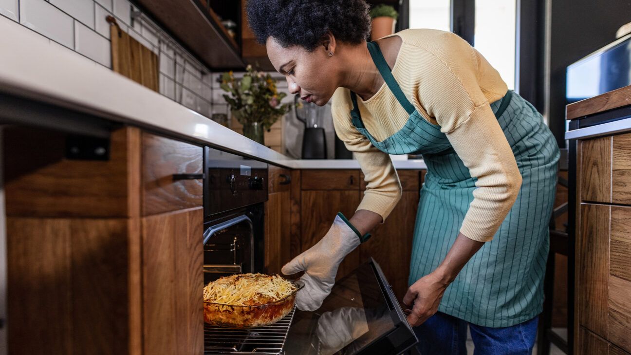 The lady cooks mac and cheese.